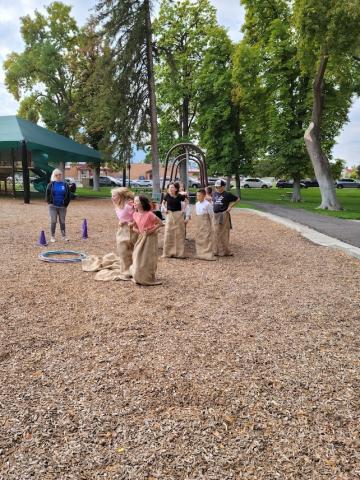 Students participating in a gunny sack race. 
