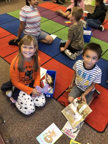 Fourth and first grade buddies reading together