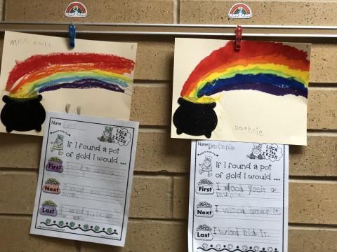 Rainbow drawings with writing about what they'd do with a pot of gold
