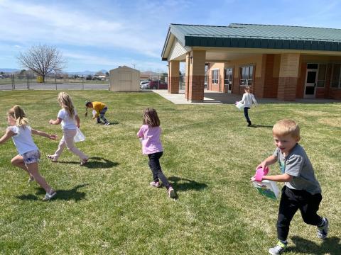 Kindergartners celebrating Spring with an egg hunt.