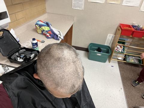 Mr. Lai  getting head shaved for students learning their 50 states
